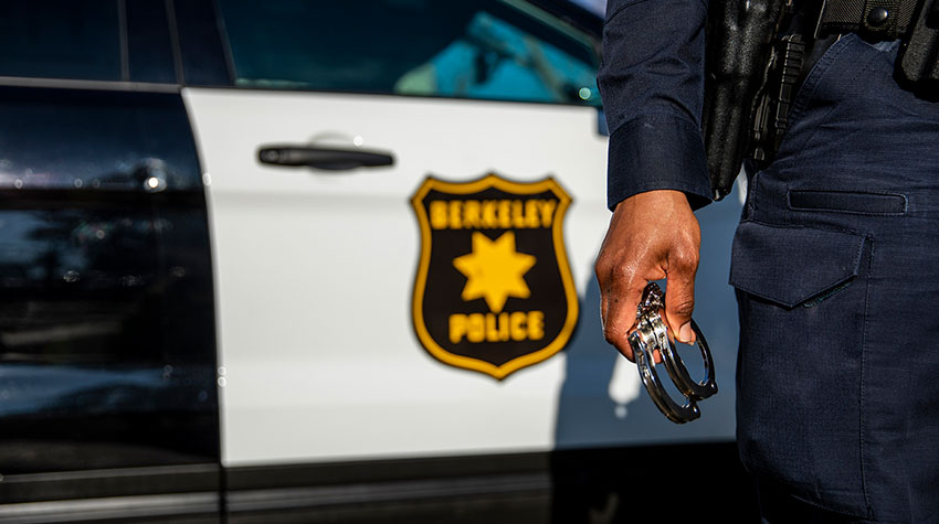 Police officer holding handcuffs