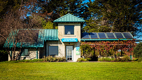 Building with solar panels in a grassy field