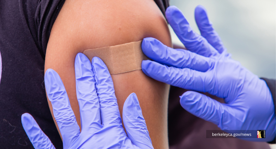 Person has a bandaid put on after their COVID booster