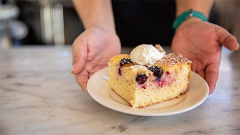 Person serving a slice of cake