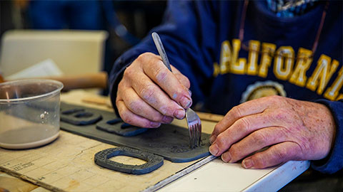 Senior creating art with clay