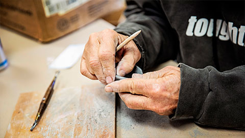 Senior creating art with clay