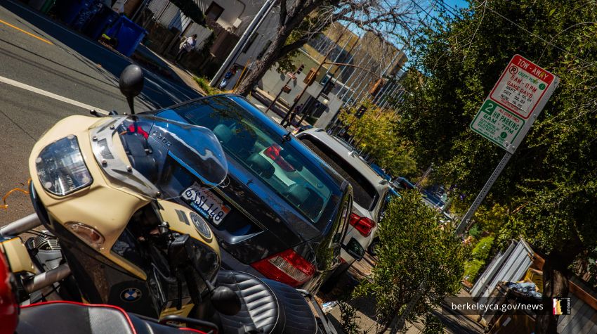 Parked cars and a motorcycle parked in a Residential Parking Permit zone