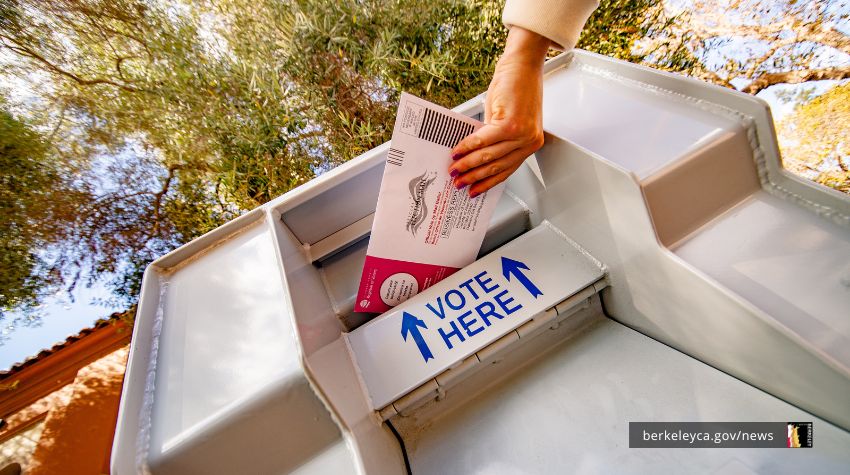 Person putting a ballot into a voting drop box