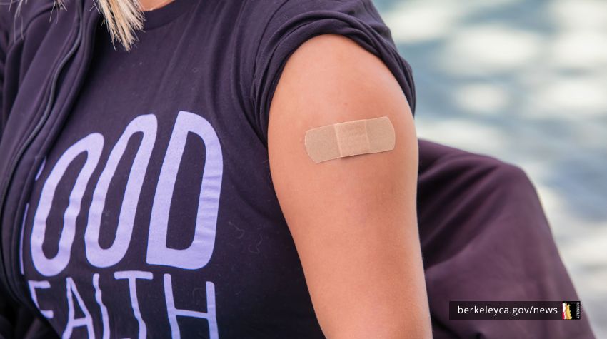 Person with adhesive bandage on their upper arm