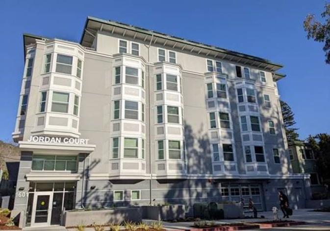 Exterior of Jordan Court building, a five-story gray building